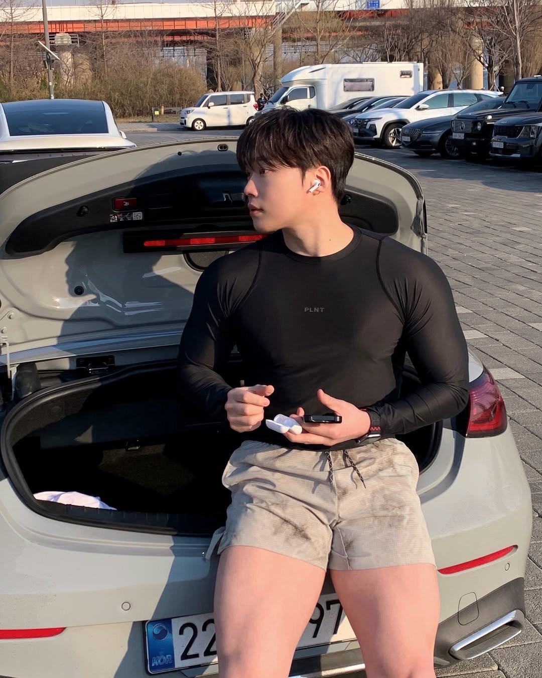 Photo shared by 지 훈 on April 01, 2026 tagging @apple. May be an image of body building, car, shorts, turtleneck and text.