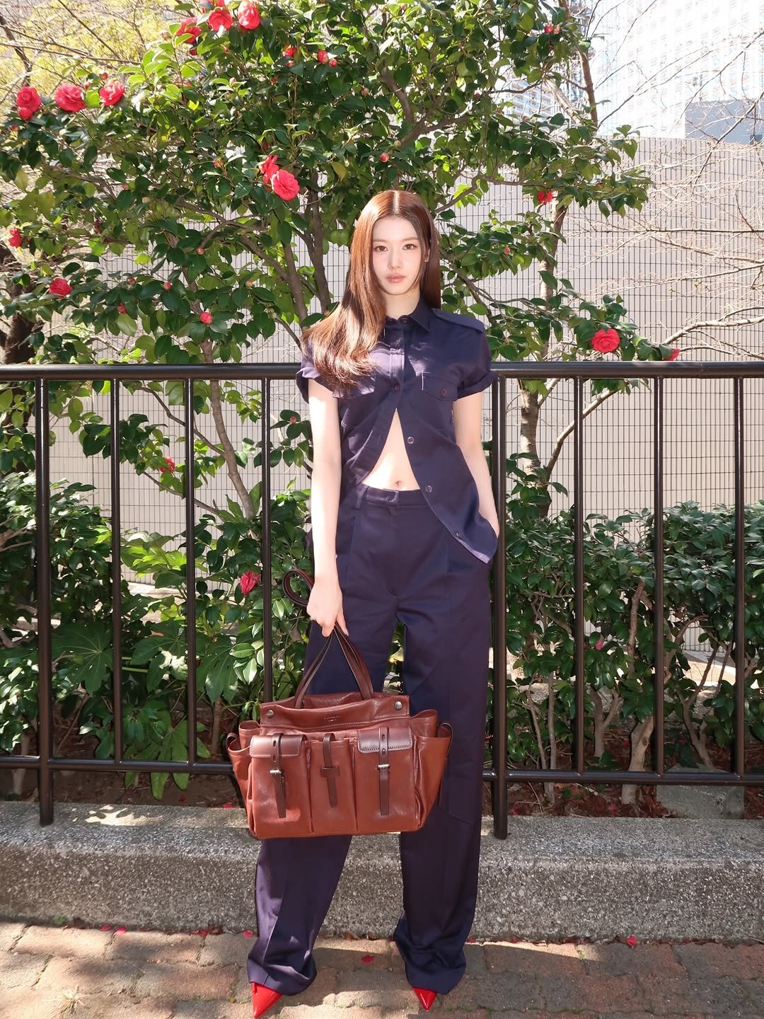 Photo shared by 사나 𝚂𝚊𝚗𝚊 on March 25, 2026 tagging @prada. May be an image of stethoscope, jumpsuit and text.