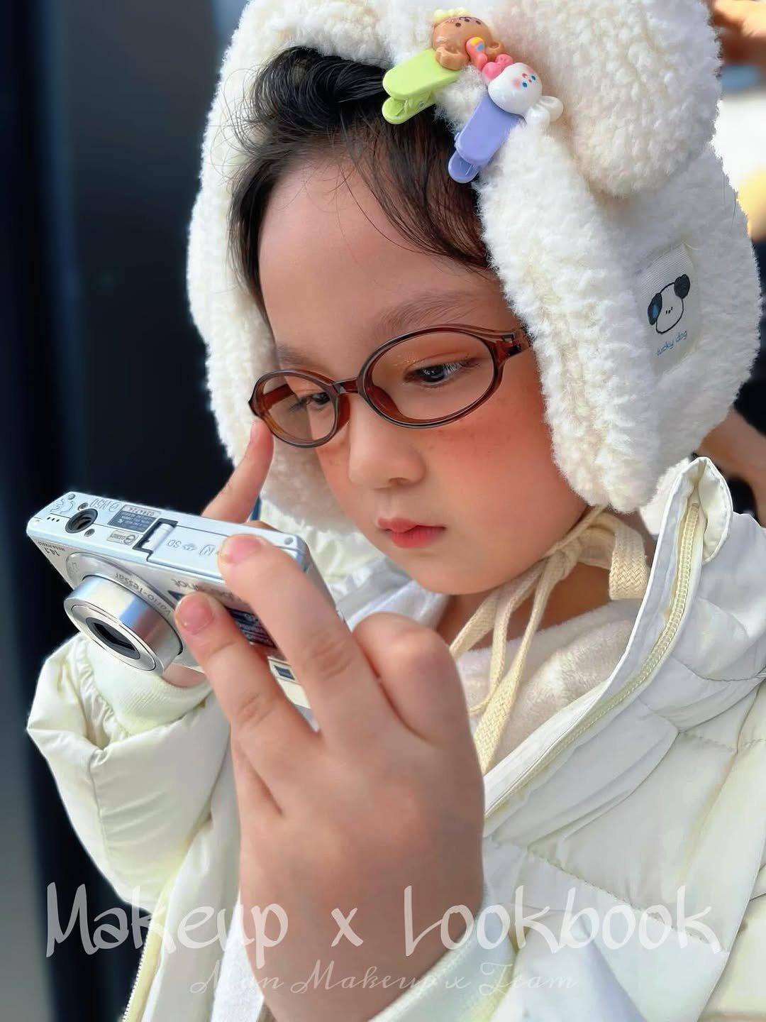 Photo by Man Makeup on October 09, 2025. May be an image of child, makeup, duffle coat, camera, portable cassette player and text.