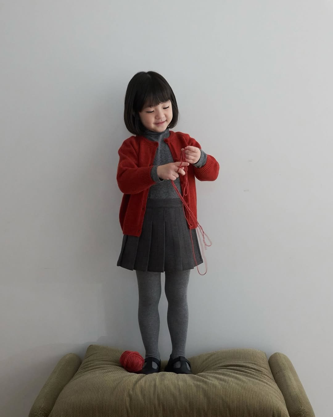 Photo by 마망블랑 mamanblanc on November 19, 2025. May be an image of baby, standing, duffle coat, cardigan and text.