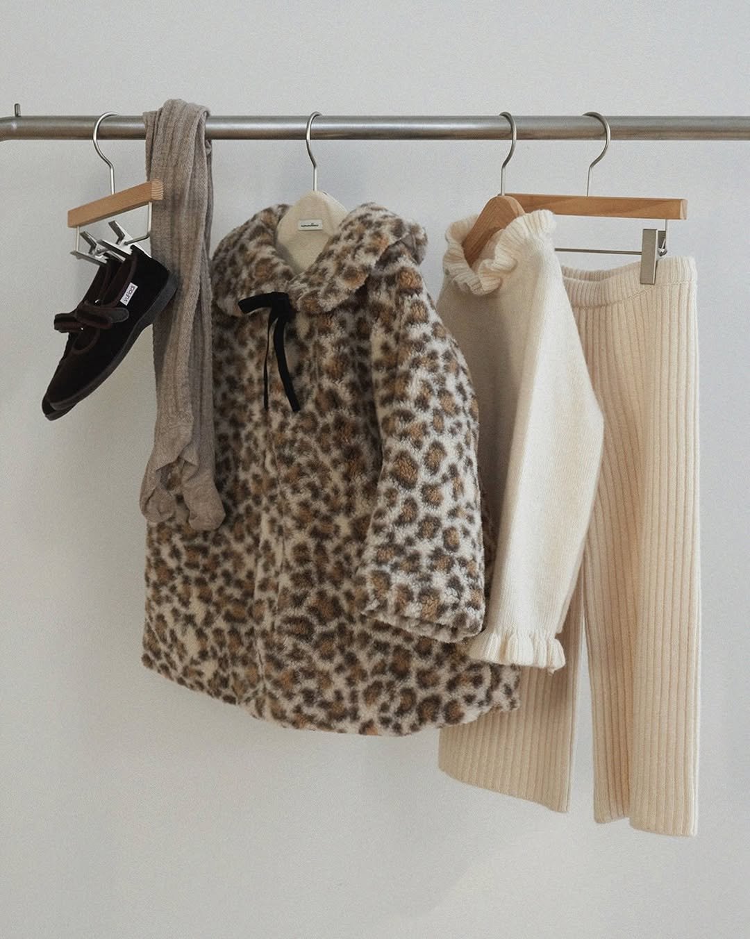 Photo by 마망블랑 mamanblanc on November 24, 2025. May be an image of clothes hanger, outerwear, rack and text.