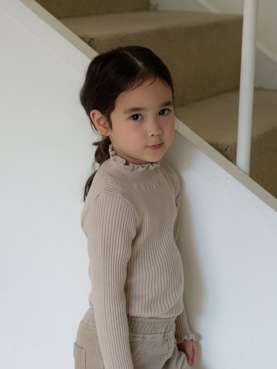 Photo by 마망블랑 mamanblanc on November 18, 2025. May be an image of child, knit, turtleneck, cardigan and text.