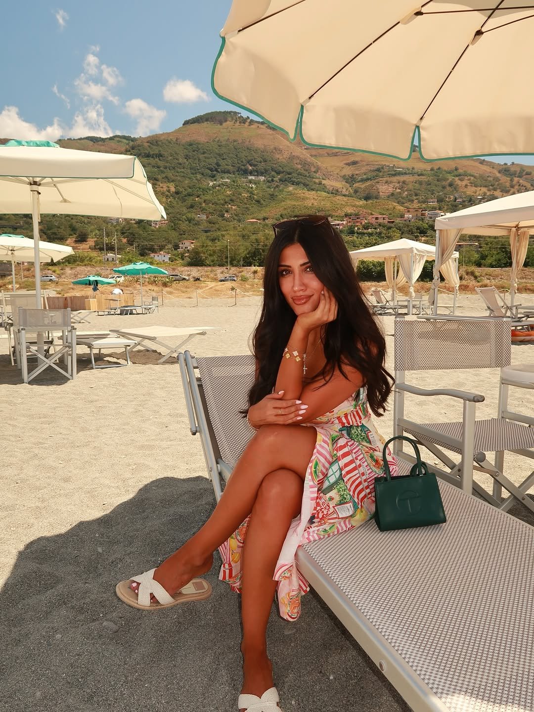 Photo shared by Maria Aiello on August 08, 2025 tagging @themariaaiello. May be an image of 1 person, sarong, parasol, deck chair, umbrella, cabana and text.