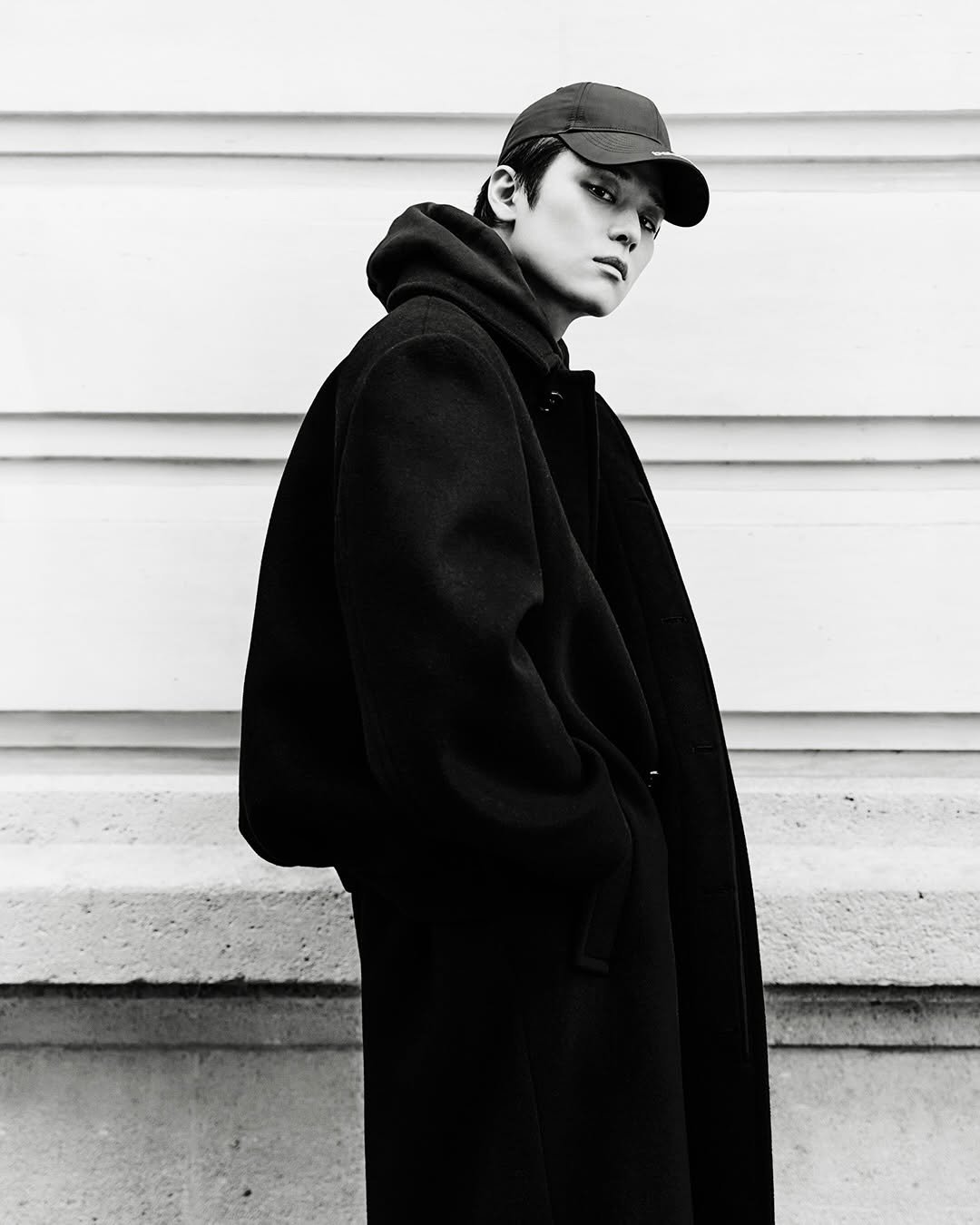 Photo shared by marie claire korea 마리끌레르 on January 16, 2026 tagging @balenciaga, @pppiccioli, @tbzuyeon, and @theboyz_officl. May be a black-and-white image of duffle coat, hat, overcoat, cloak, parka, turtleneck and text.