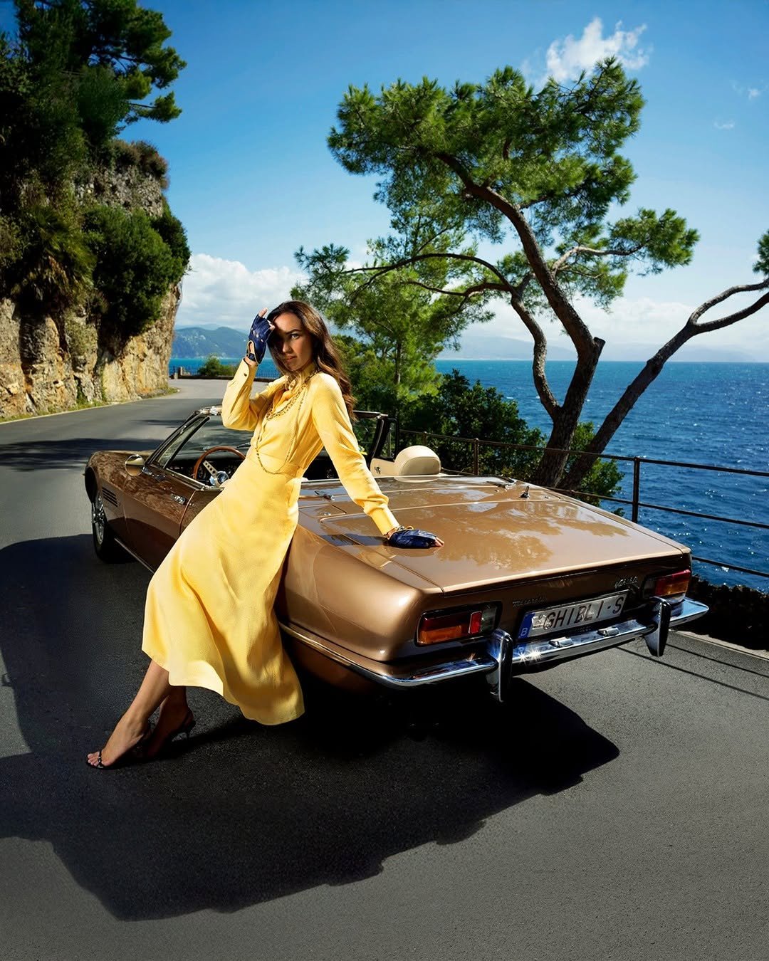 Photo by Maserati on September 22, 2025. May be an image of 1 person, car, headscarf, convertible, parasol, road and text.