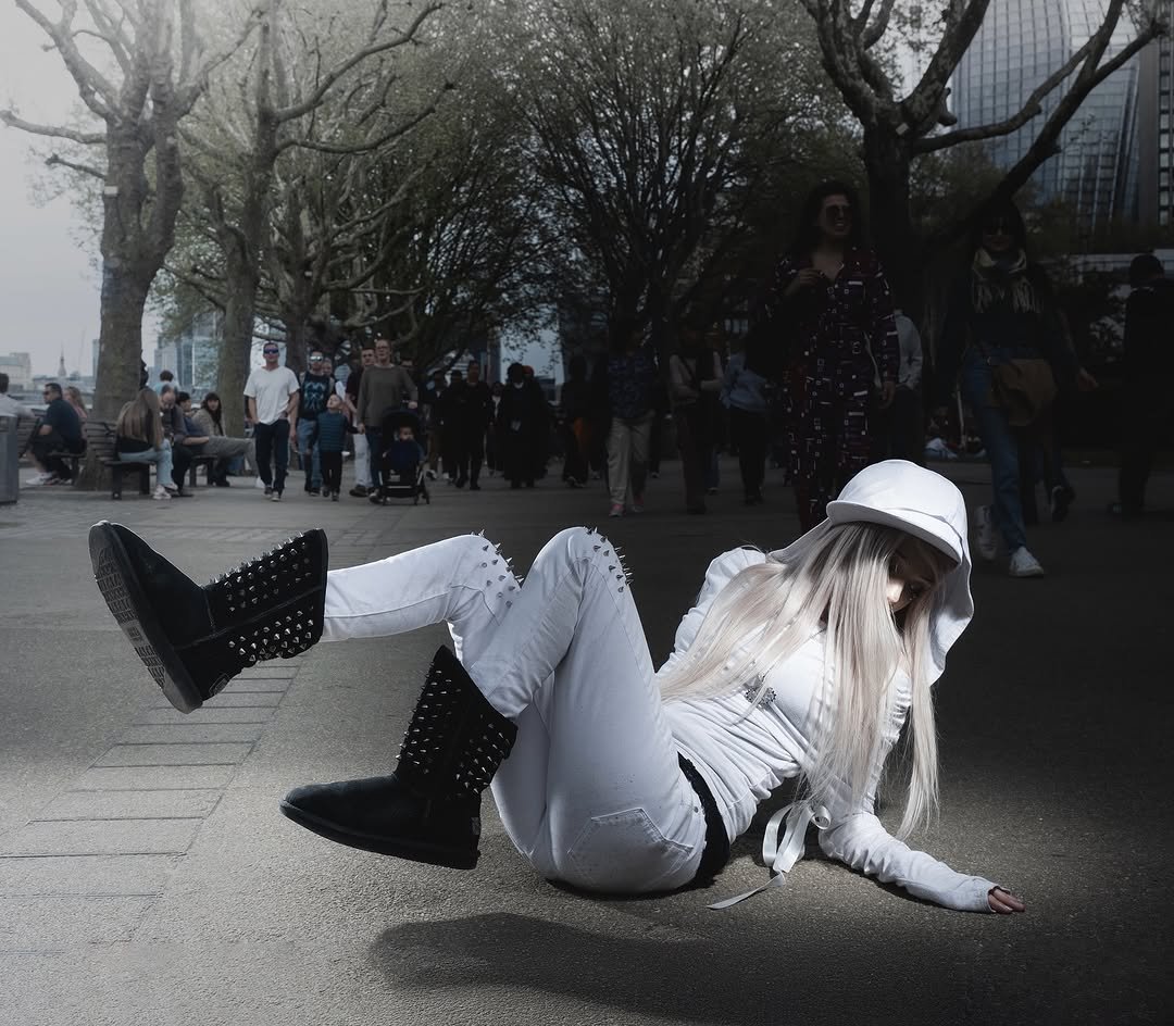 Photo shared by Max Durante on November 13, 2025 tagging @maxgr1mes, @morriganrawson, and @roxxyshay. May be an image of standing, gas mask, bowler hat, beret, fishnet stockings, street and text.