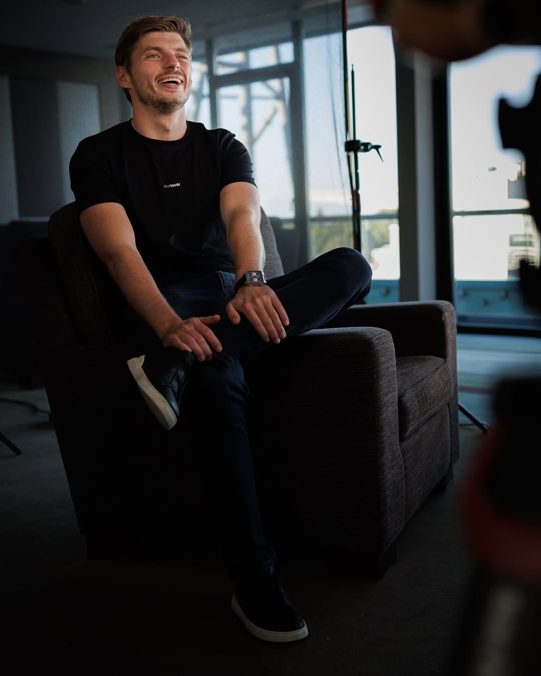 Photo by Max Verstappen on February 17, 2026. May be an image of one or more people, people smiling, camera, tripod, office and text.