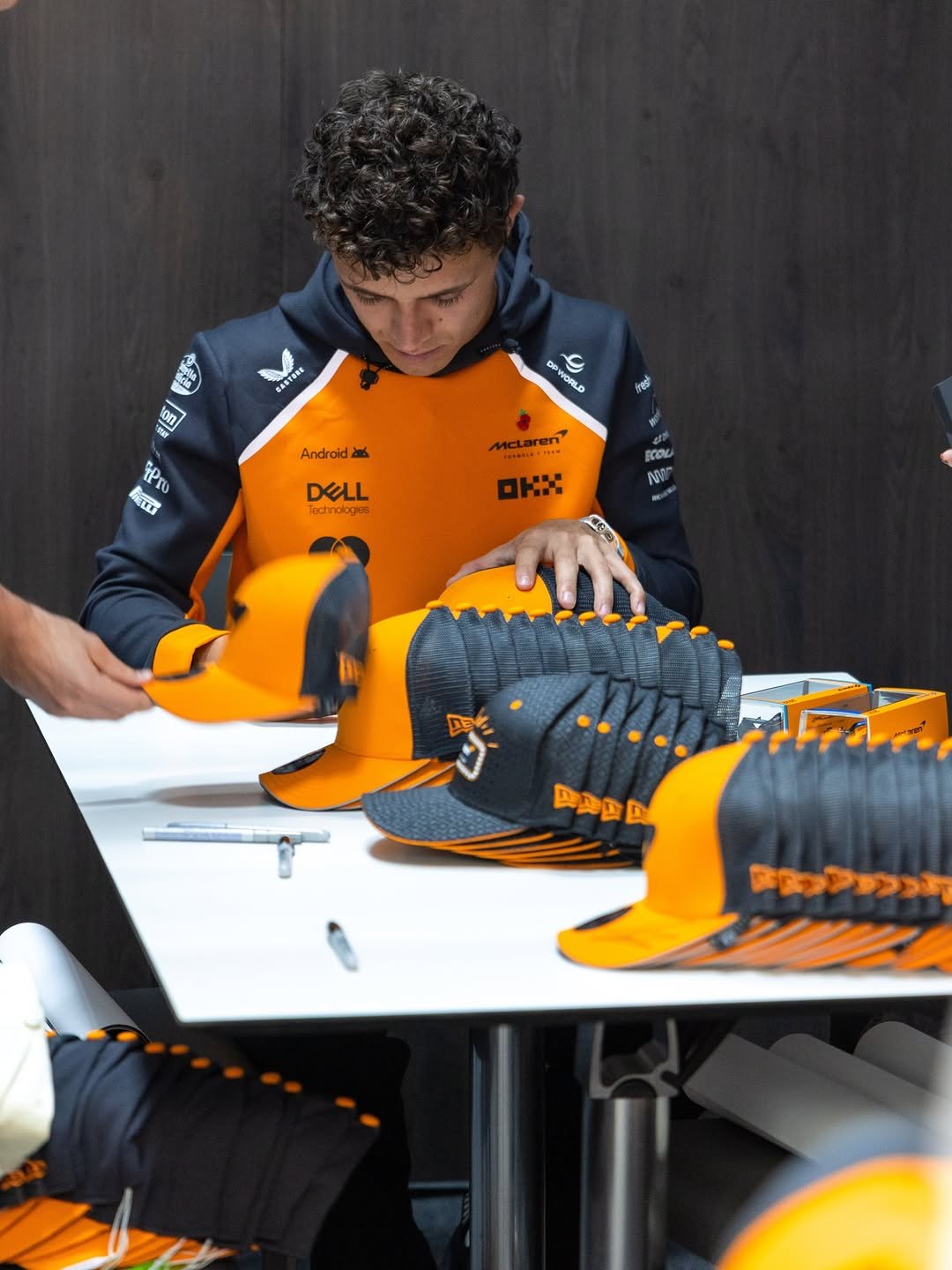 Photo shared by McLaren on November 06, 2025 tagging @lando. May be an image of racing vehicles, hat, helmet and text.