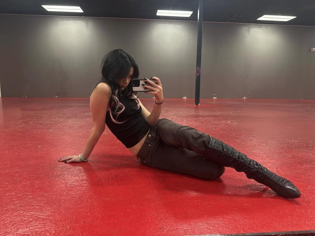 Photo by MEGAN MEI-YOK SKIENDIEL on December 09, 2025. May be an image of dancing, fishnet stockings, pole and text.