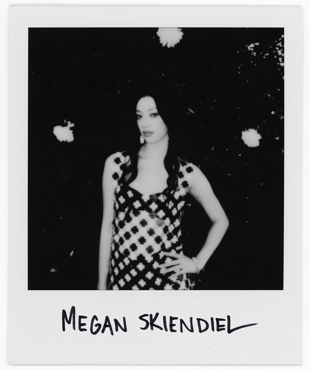 Photo shared by laufey on April 06, 2026 tagging @meganskiendiel. May be a black-and-white image of one or more people, makeup, polaroid and text that says 'MEGAN SKIENDIEL SKIENDIE'.