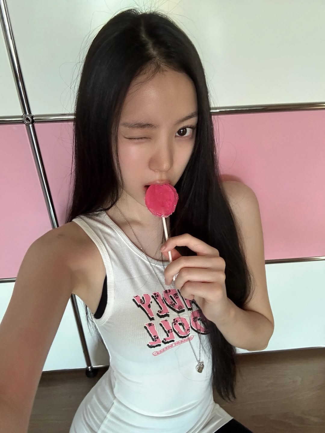 Photo by MEOVV on August 12, 2025. May be an image of 1 person, hair, chewing bubblegum, lollipop and text.
