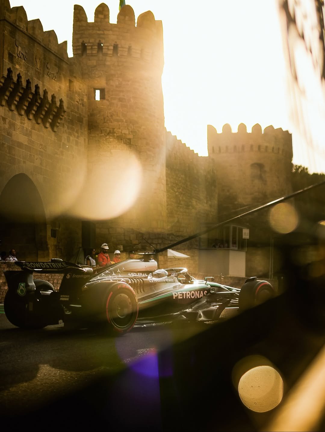 Photo shared by Mercedes-AMG Motorsport on September 22, 2025 tagging @mercedesamgf1, @mercedesamg, @georgerussell63, @mercedesbenzaz, and @bakucitycircuit. May be an image of the Palais des Papes, castle and text.