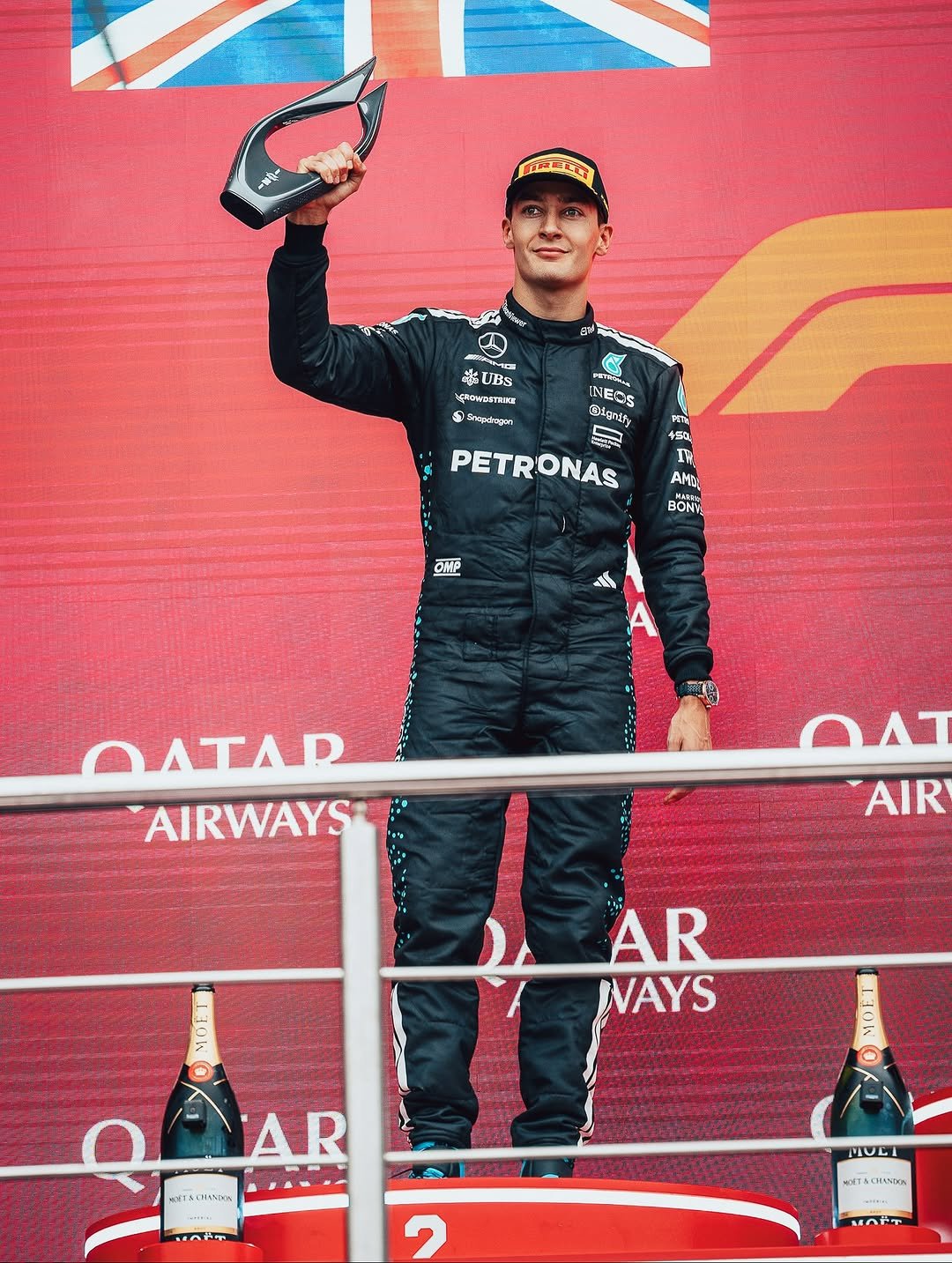 Photo shared by Mercedes-AMG Motorsport on September 21, 2025 tagging @mercedesamgf1, @mercedesamg, @georgerussell63, @f1, and @mercedesbenzaz. May be an image of 1 person, racing a vehicle, race car, helmet and text.