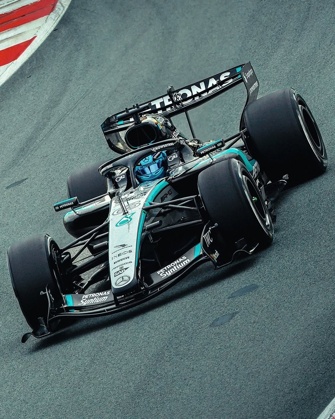 George Russell driving the Mercedes-AMG F1 W17 on the circuit de Barcelona-Catalunya during testing in January. The car is in the middle of the track, with red and white kerb visible in the top left of the image.