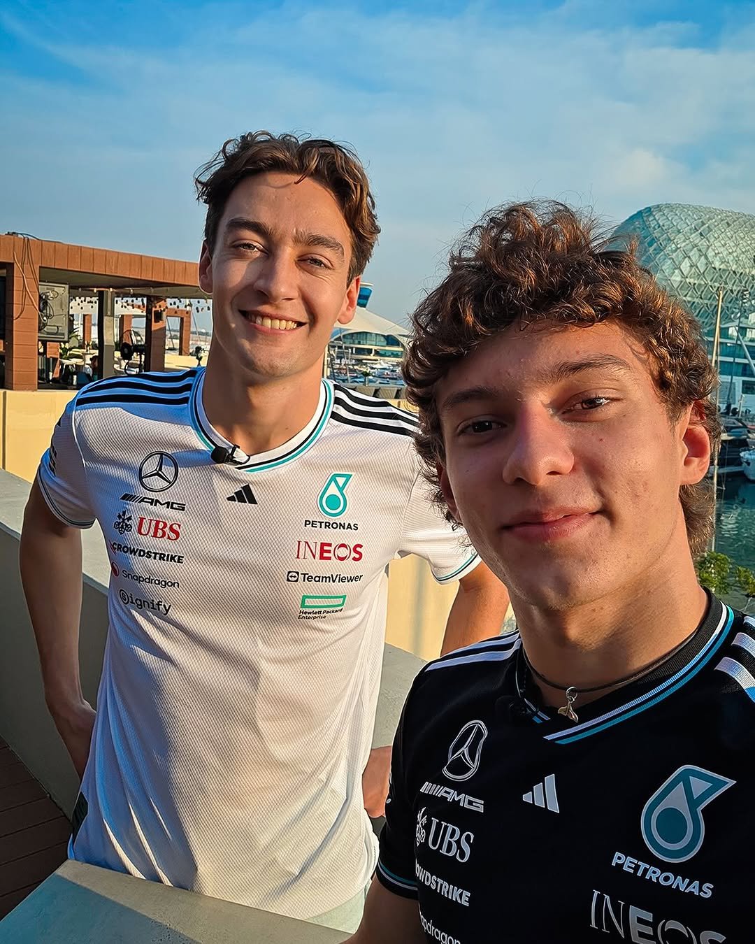 George Russell and Kimi Antonelli taking a selfie together in Abu Dhabi