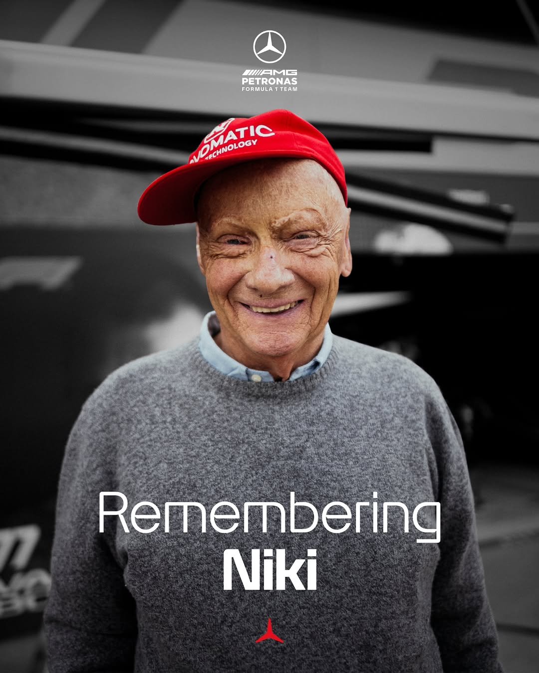 A graphic featuring Niki Lauda wearing his trademark red cap and smiling. Text on the graphic reads 'Remembering Niki' and features the red star.