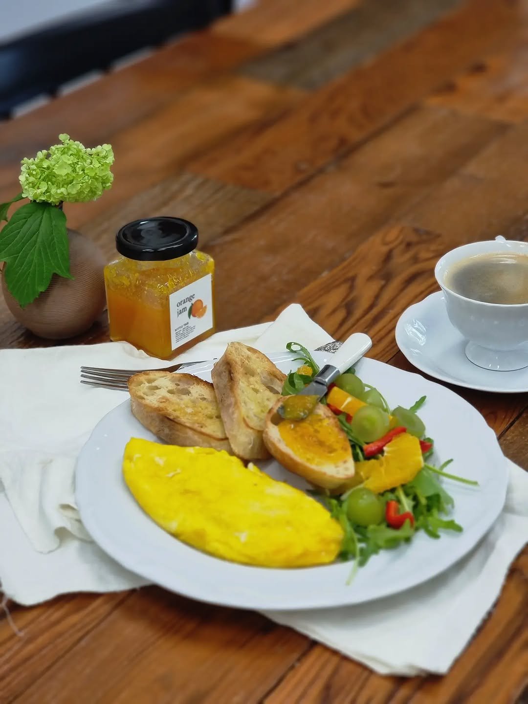 Photo by merry J on April 20, 2026. May be an image of baguette, omelet, tomato, scrambled eggs, hollandaise, preserves and text.