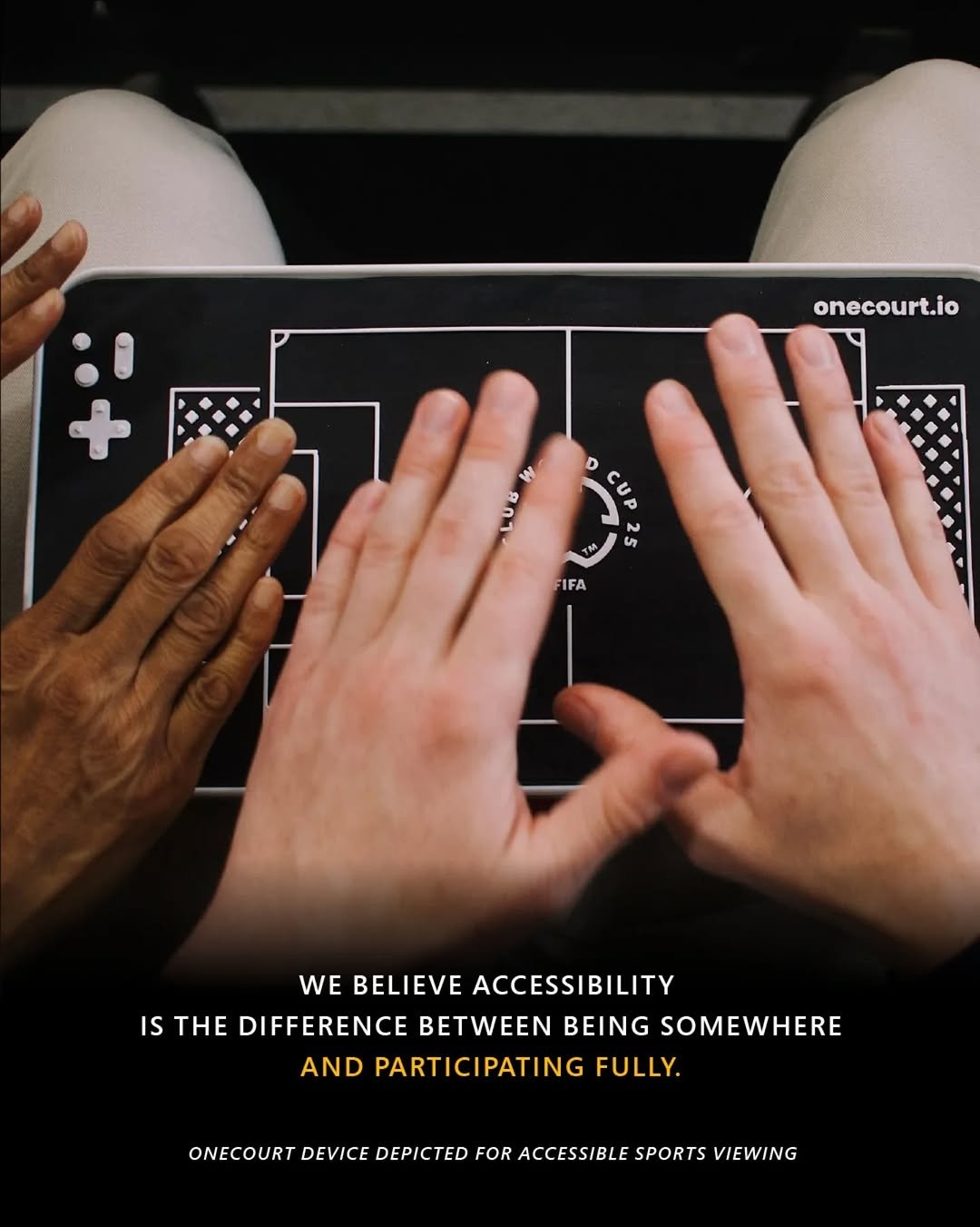 Photograph showing hands interacting with a OneCourt device - a tactile sports viewing device designed for accessibility, featuring a raised, simplified soccer field layout with goal areas and center circle. The device uses contrasting black and white colors and textured elements to enable visually impaired users to follow soccer matches through touch.
