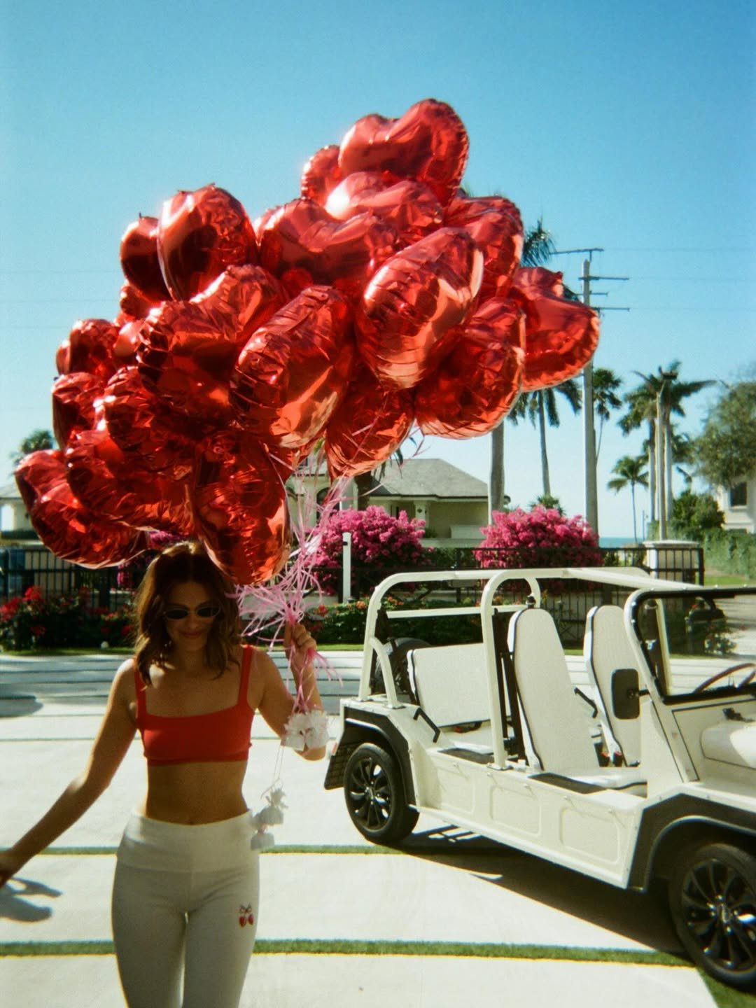 Photo shared by Millie Bobby Brown on February 13, 2026 tagging @nordstrom. May be an image of golf cart, balloon, miniskirt and text.