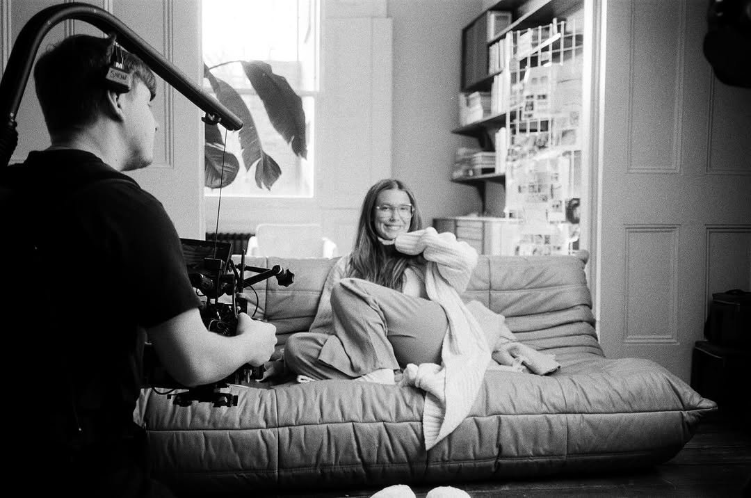 Photo by Millie Bobby Brown on October 19, 2025. May be a black-and-white image of camera, tripod, camcorder and text.