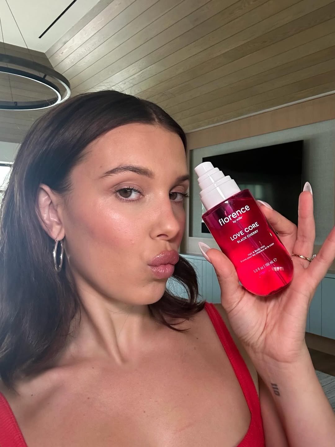 Photo shared by Millie Bobby Brown on February 11, 2026 tagging @douglascosmetics_es, @nocibe_france, @douglas_cosmetics, @douglas_polska, and @florencebymills. May be an image of one or more people, makeup, fragrance, hand cream, perfume and text.