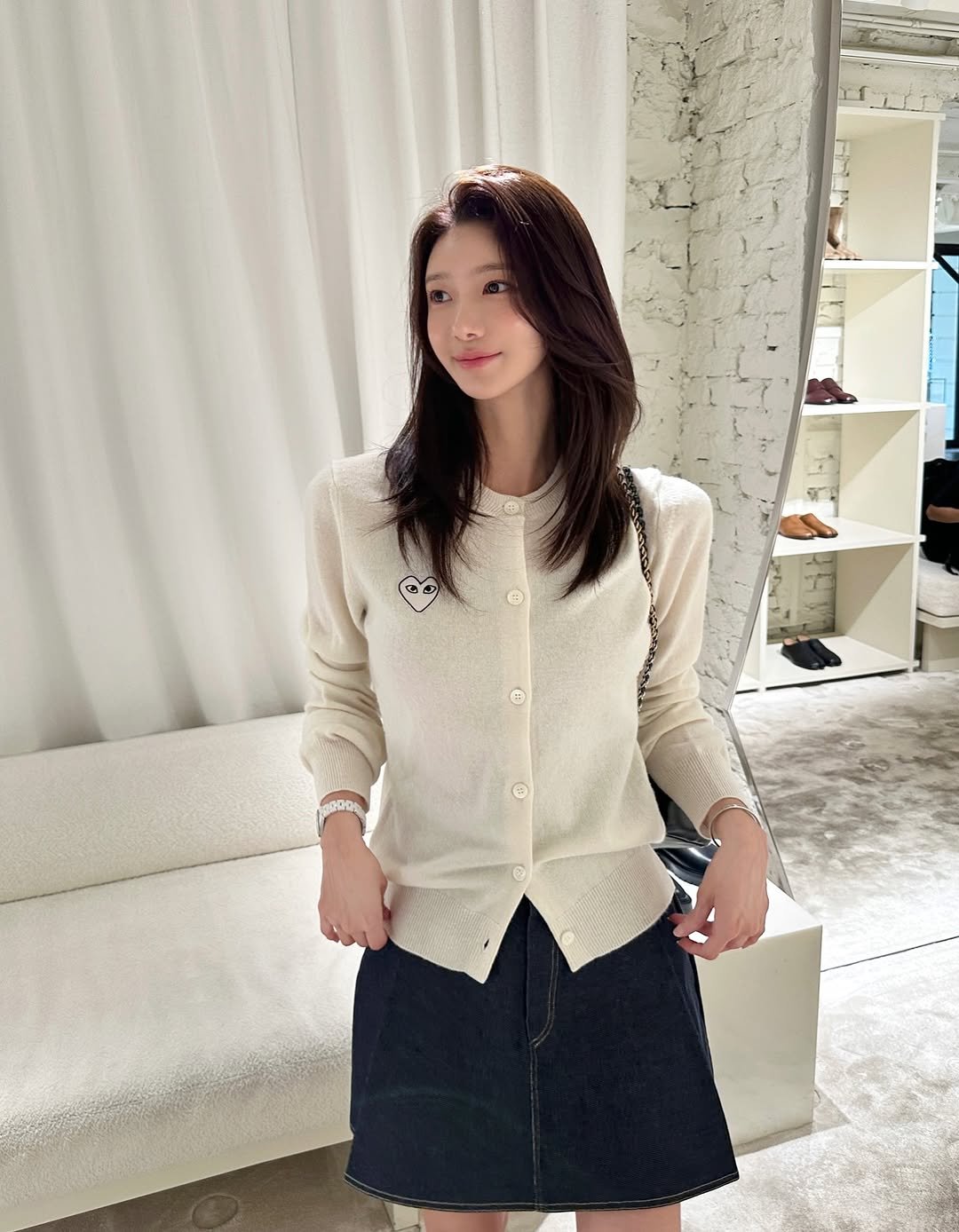 Photo by 김민희 on September 06, 2025. May be an image of 1 person, miniskirt, cardigan, skirt, top and text.