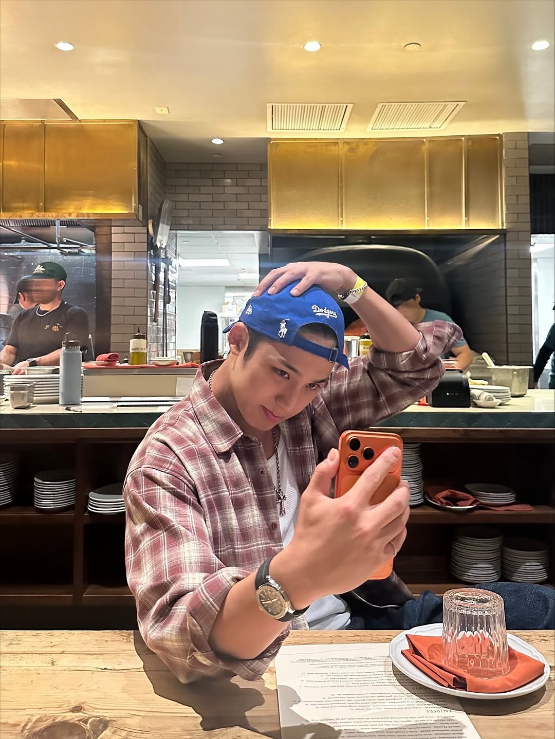 Photo by 김민규 on November 01, 2025. May be an image of one or more people, phone, hat and text.