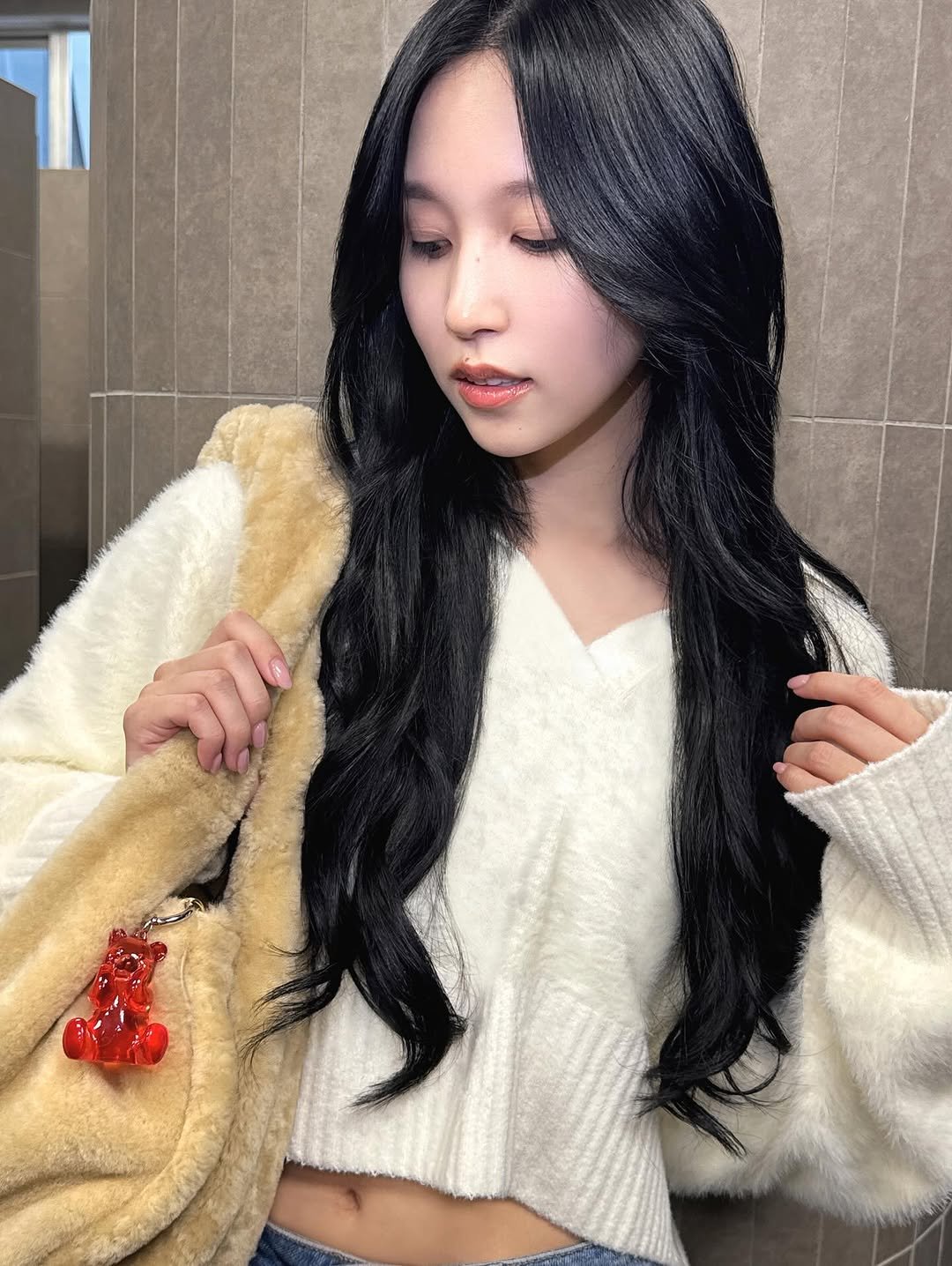 Photo shared by SK-II Japan on November 28, 2025 tagging @skii, and @mina_sr_my. May be a selfie of one or more people, braids, duffle coat, sweater, top and text.