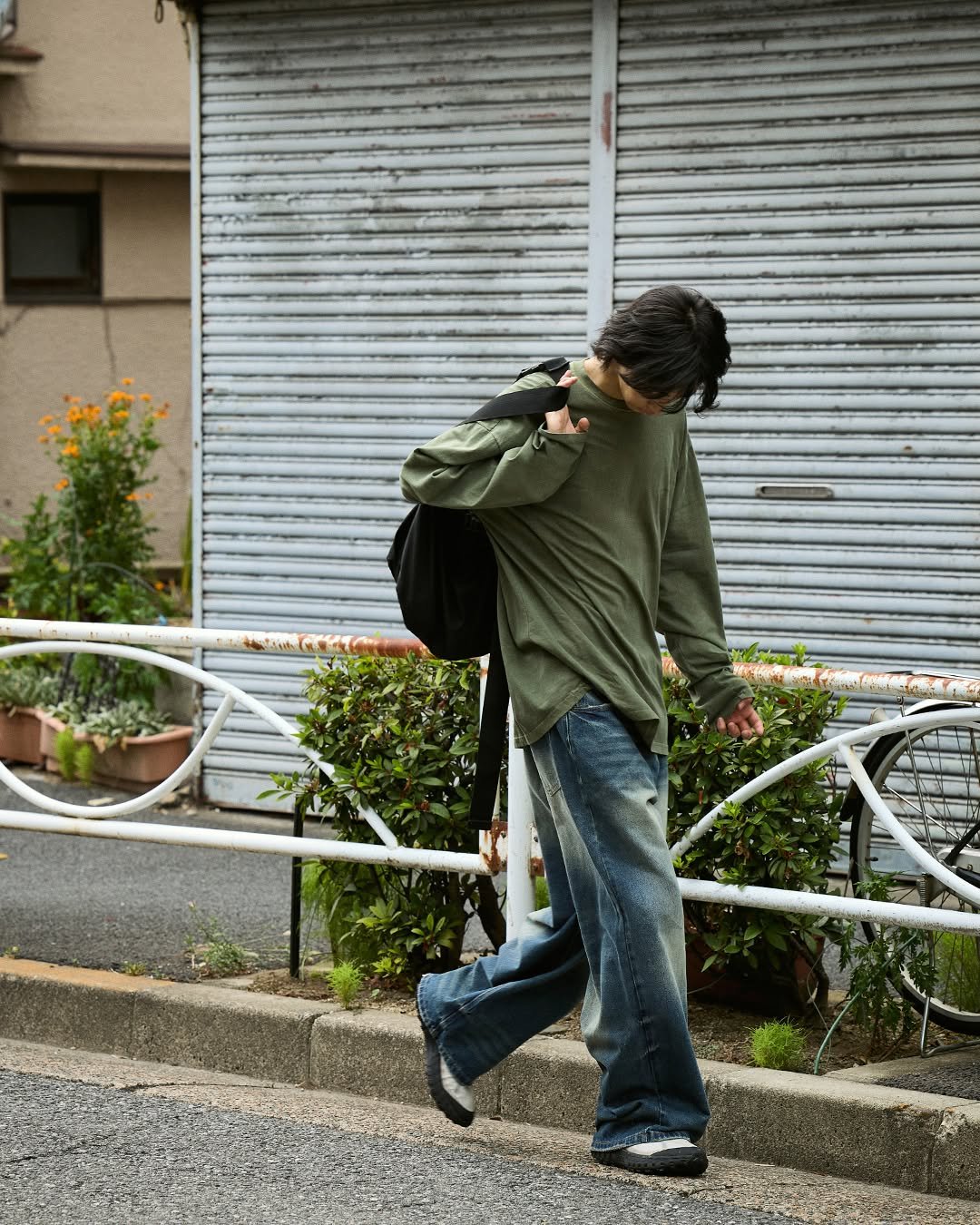 Photo by MINIMALPROJECT on August 18, 2025. May be an image of one or more people, cigarette, street and curb.