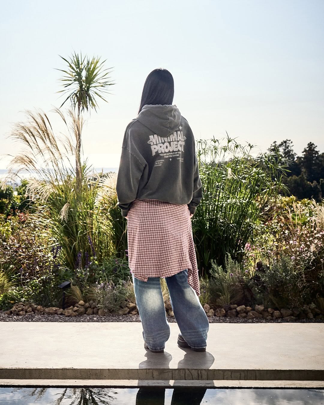 Photo by MINIMALPROJECT on March 24, 2026. May be an image of standing, sweatpants, parka, outdoors and text.