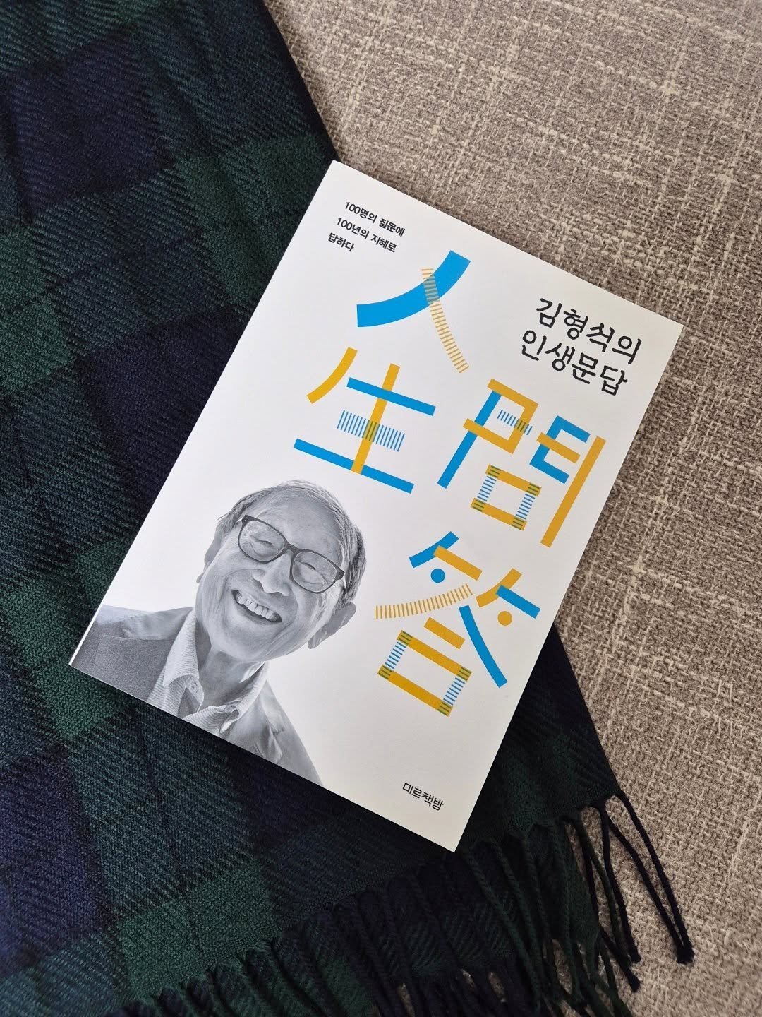 Photo by 미류책방 on October 20, 2025. May be an image of scarf, duffle coat, shawl, book, magazine and text.