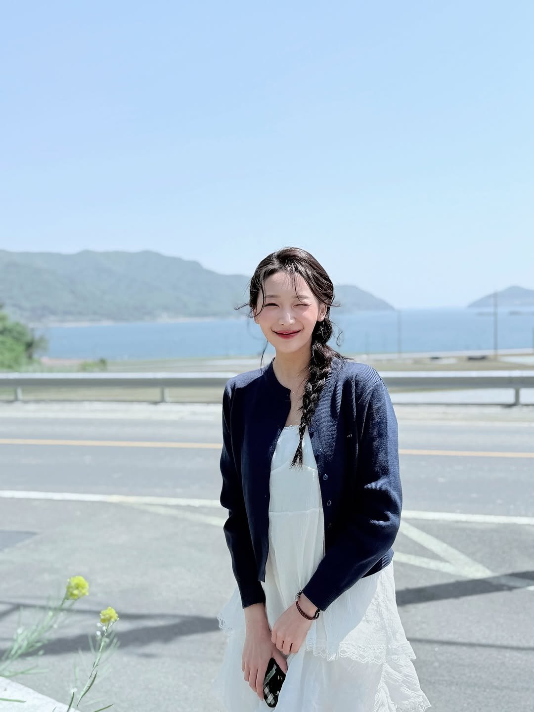 Photo by 미소지오misozio on August 01, 2025. May be an image of 1 person, braids, sundress, dress, outdoors and text.