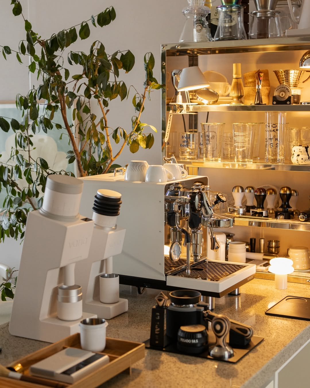 Photo shared by Megan | 메건's home on September 29, 2025 tagging @artemide_lighting, @pesado58.5, @elrocioespressomachine, and @variabrewing. May be an image of tea maker, coffee maker, grinder, kitchen appliance, rack, carafe and text.