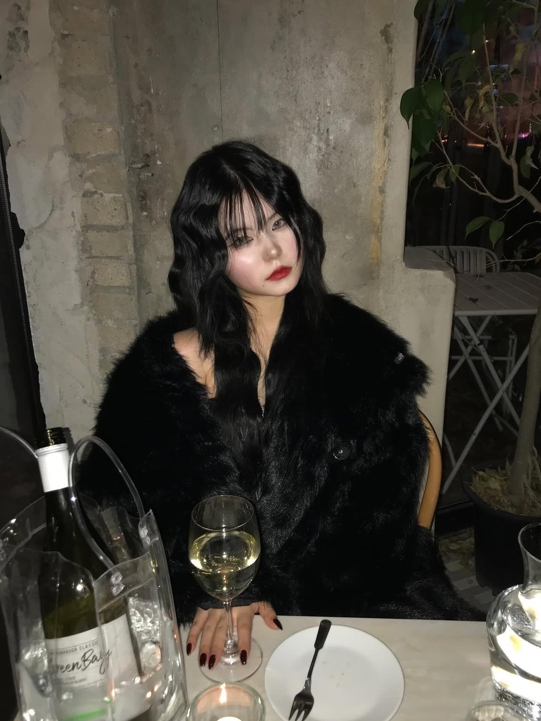 Photo shared by Hyebin Kim on December 25, 2025 tagging @odor_kr. May be an image of one or more people, hair, fur coat, wine glass, parka and text.