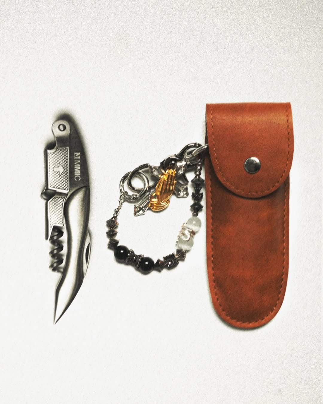 Photo by MMIC (엠엠아이씨) on September 05, 2025. May be an image of knife, saddle-stitched leather, lighter, pocket knife, dagger and text.