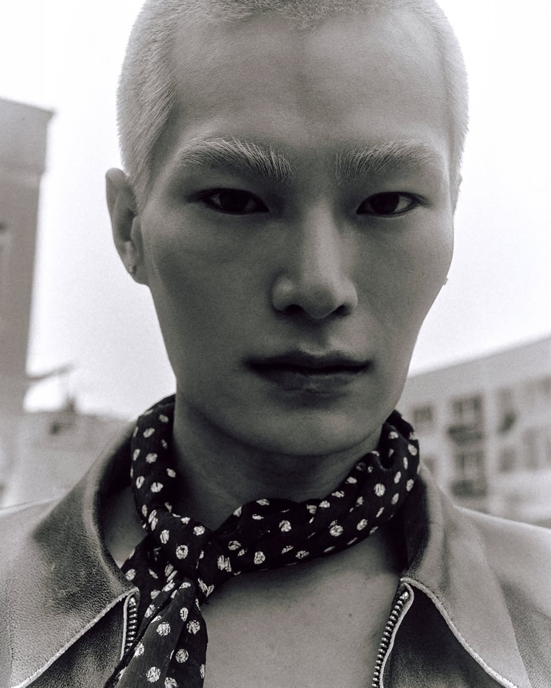 Photo by MMIC (엠엠아이씨) on February 15, 2026. May be an image of one or more people, hair, makeup, turtleneck, bolo tie, bandanna and text.