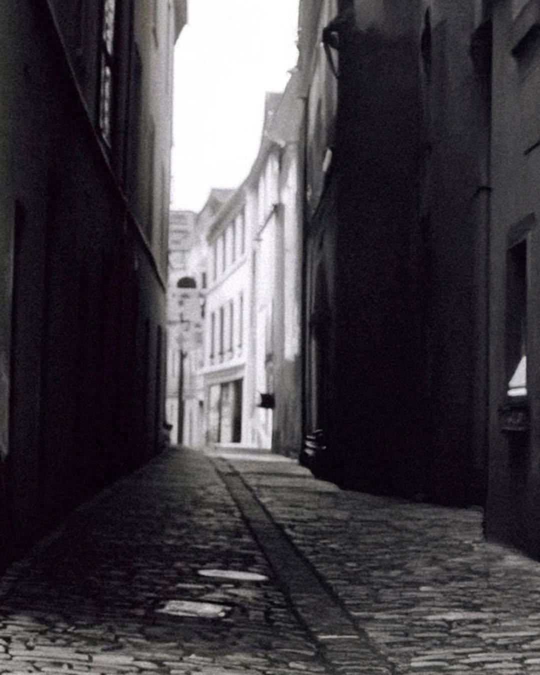 Photo by MMIC (엠엠아이씨) on February 08, 2026. May be a black-and-white image of street, hallway and text.