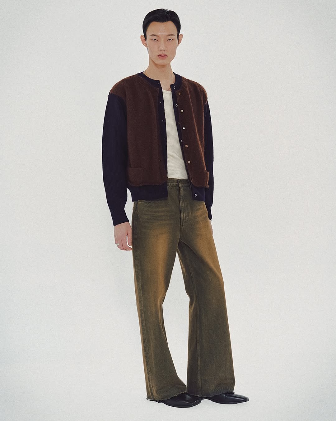 Photo by MMIC (엠엠아이씨) on October 27, 2025. May be an image of duffle coat, overcoat, turtleneck and text.