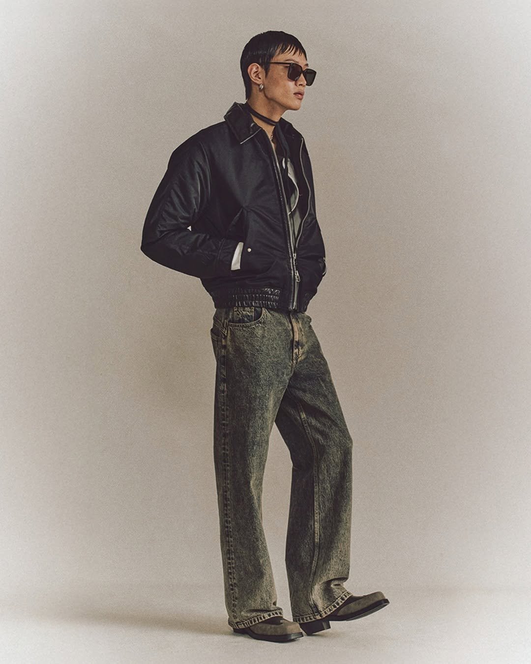 Photo by MMIC (엠엠아이씨) on October 22, 2025. May be an image of eyewear, jacket, turtleneck and text.