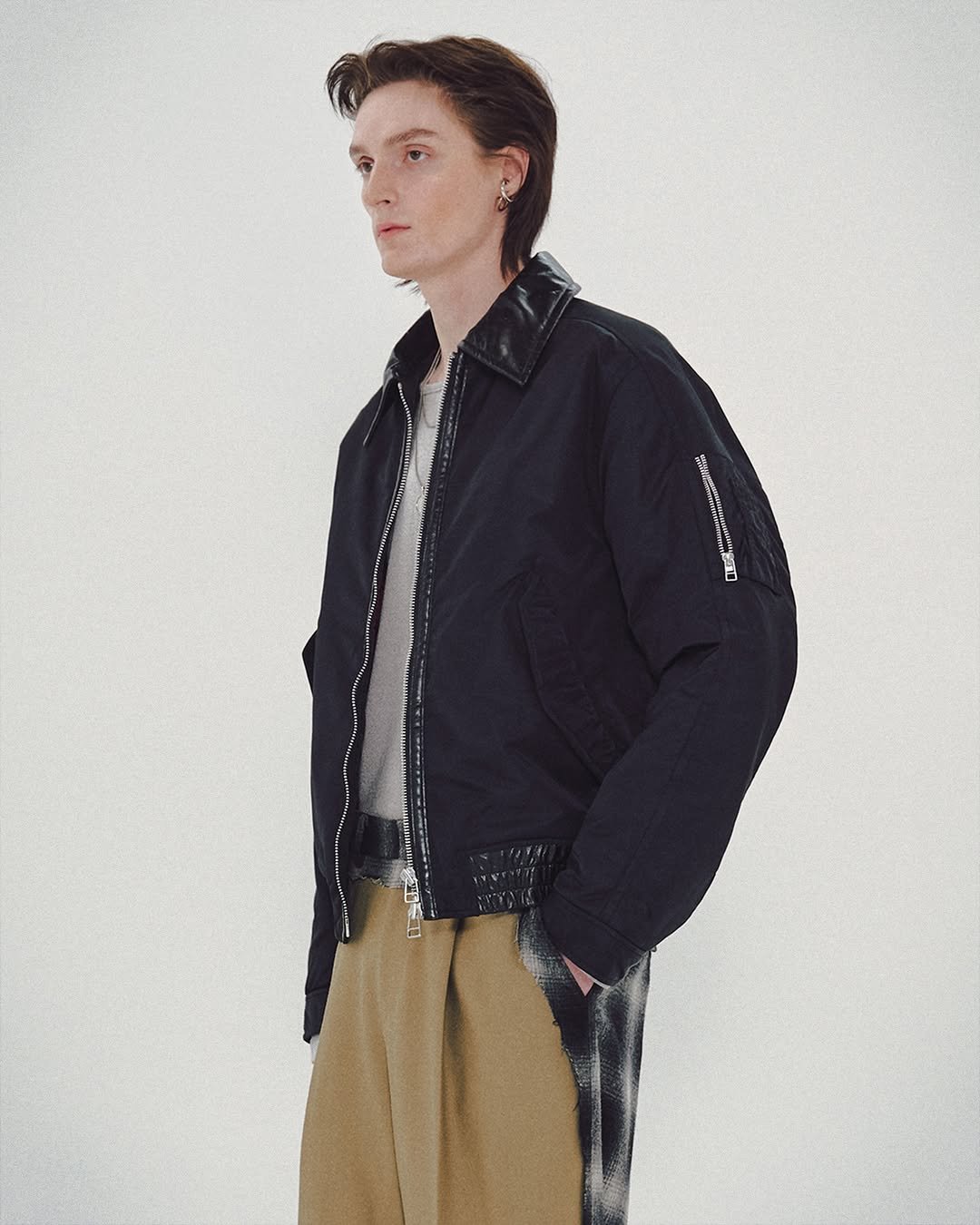 Photo by MMIC (엠엠아이씨) on October 27, 2025. May be an image of overcoat, flight jacket and text.