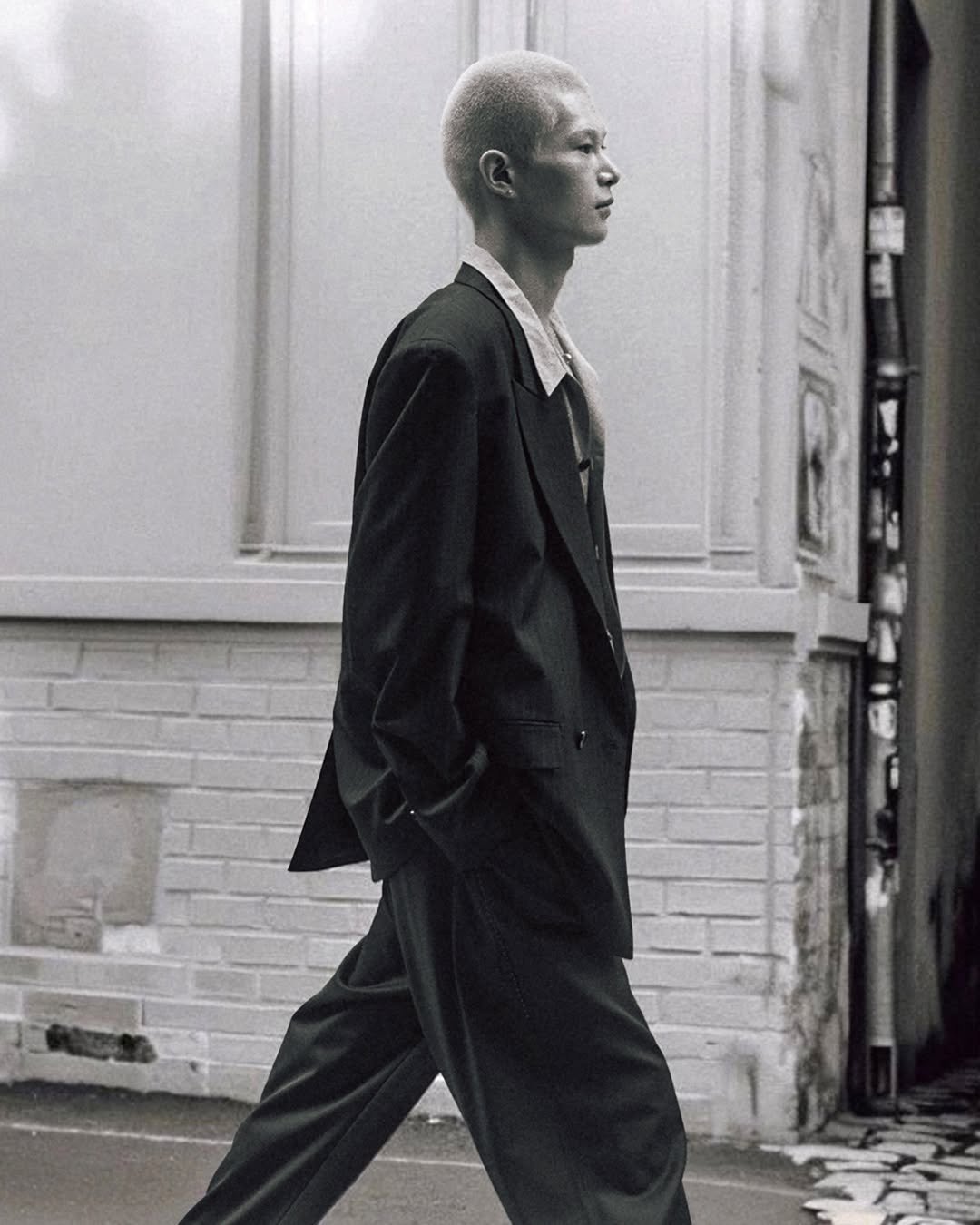 Photo by MMIC (엠엠아이씨) on February 08, 2026. May be a black-and-white image of overcoat, blazer, suit and text.