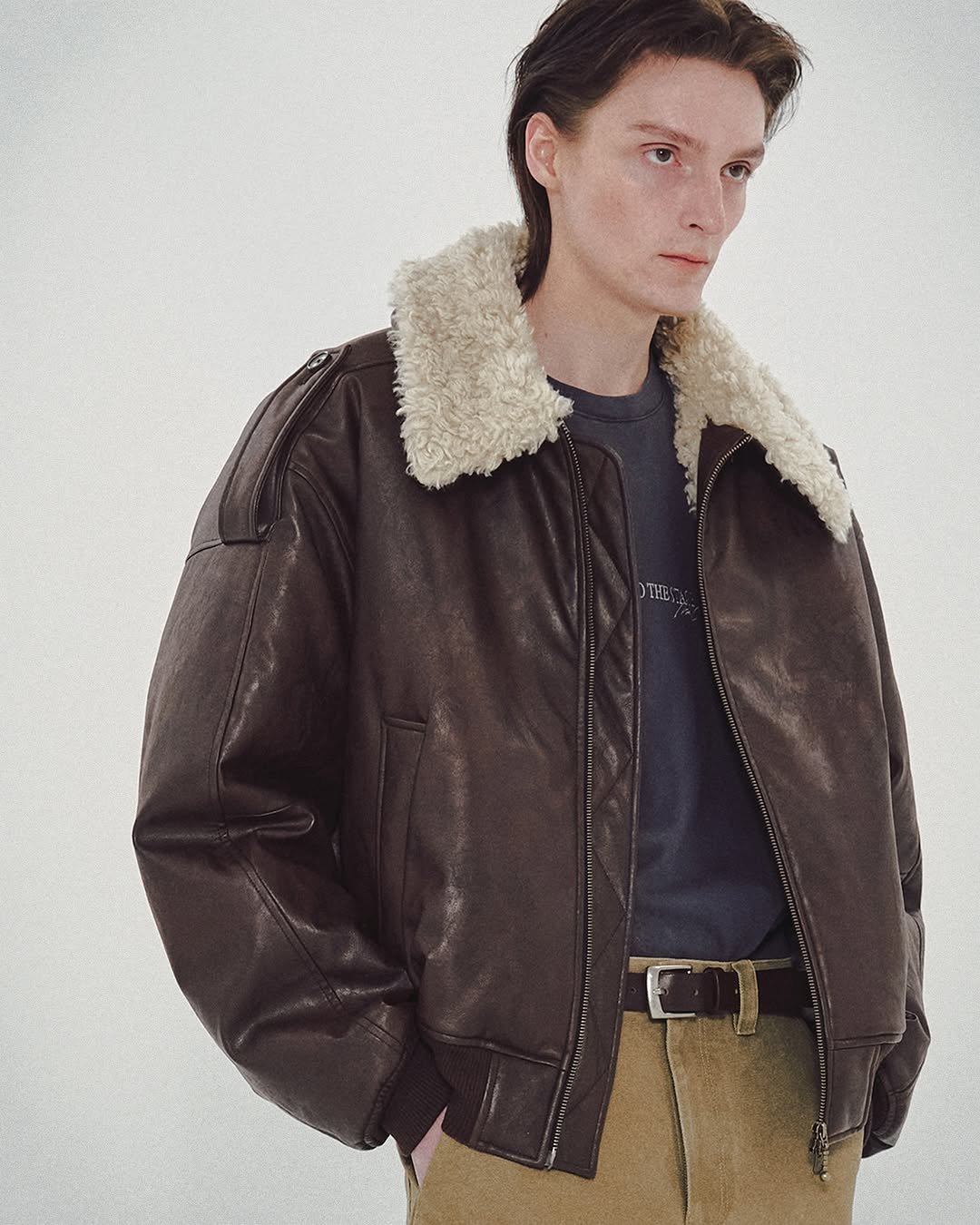 Photo by MMIC (엠엠아이씨) on October 26, 2025. May be an image of leather, flight jacket, coat and text.