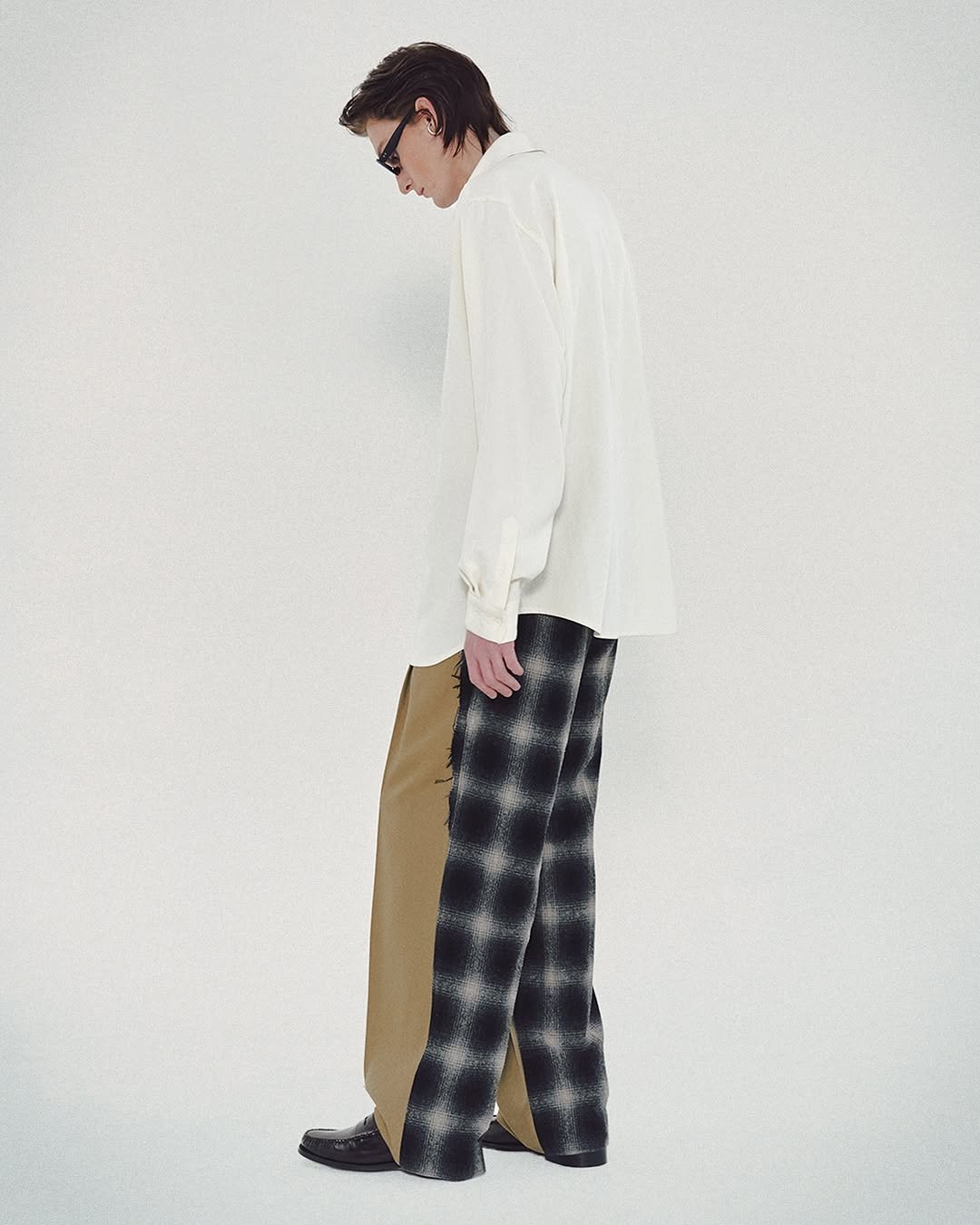 Photo by MMIC (엠엠아이씨) on October 26, 2025. May be an image of overcoat, suit, kilt and text.