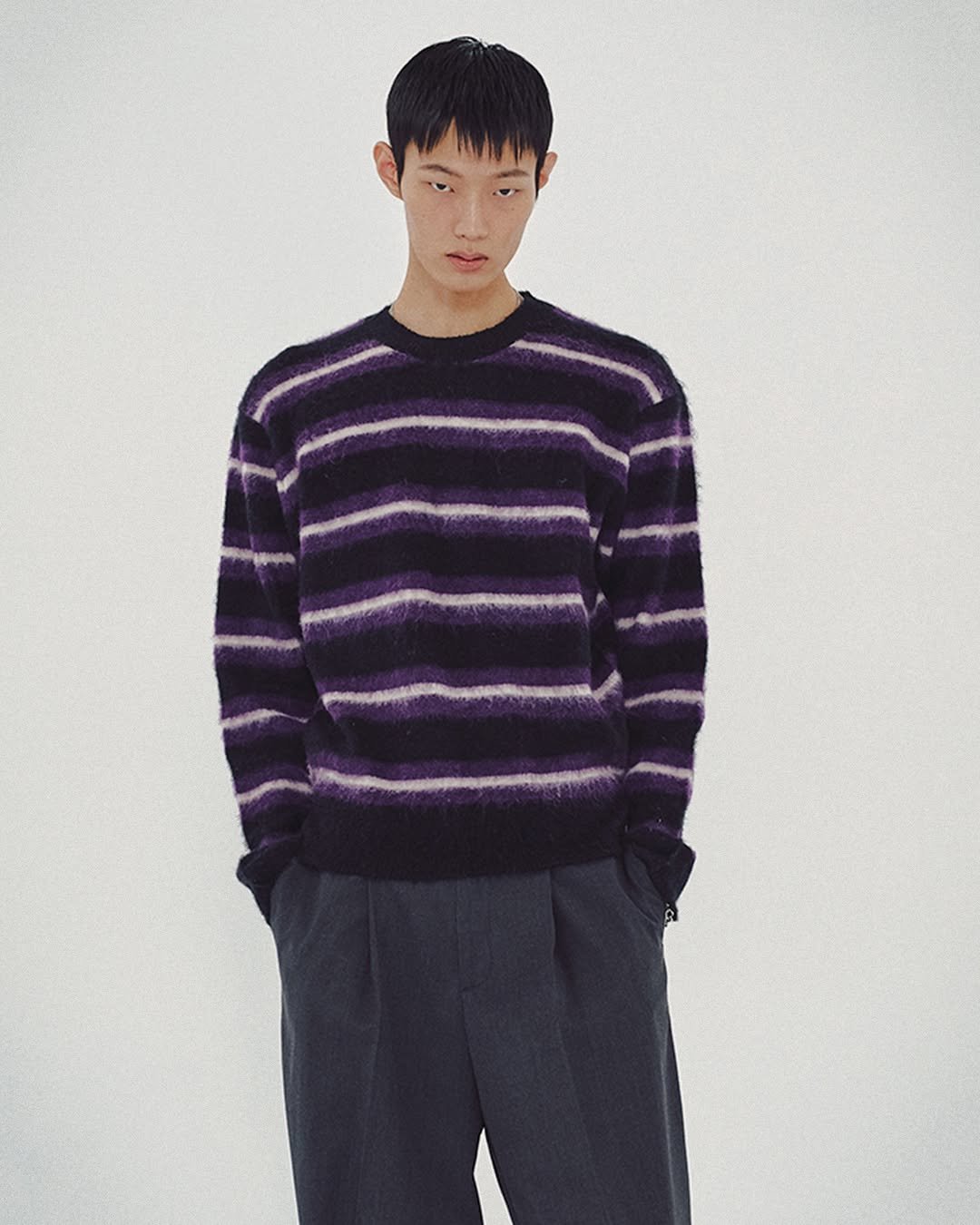 Photo by MMIC (엠엠아이씨) on October 28, 2025. May be an image of duffle coat, turtleneck, knit, sweater and text.