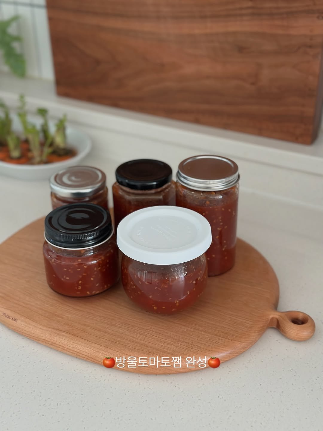 Photo by 모모키친 on December 20, 2025. May be an image of jar, condiment, sauce, tomato, preserves and text that says 'Tiub STL.D0 AW 방울토마토잼 완성'.