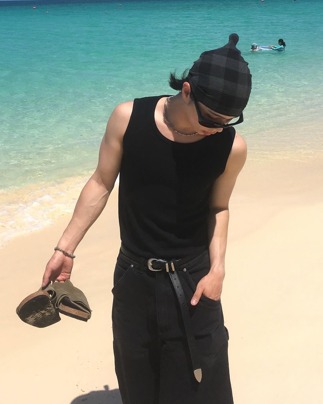 Photo shared by 민 서 on July 31, 2025 tagging @wmc_official. May be an image of 3 people, hat, glasses, beach, ocean and text.