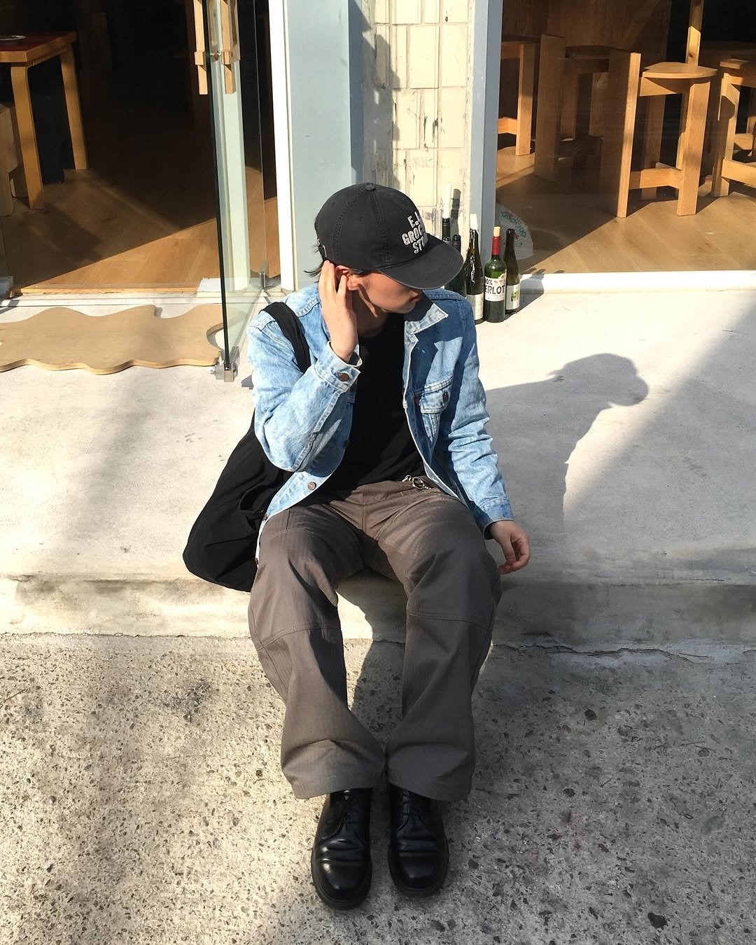 Photo by 민 서 on April 12, 2026. May be an image of wingtip shoes, duffle coat, hat, cornflower and text.