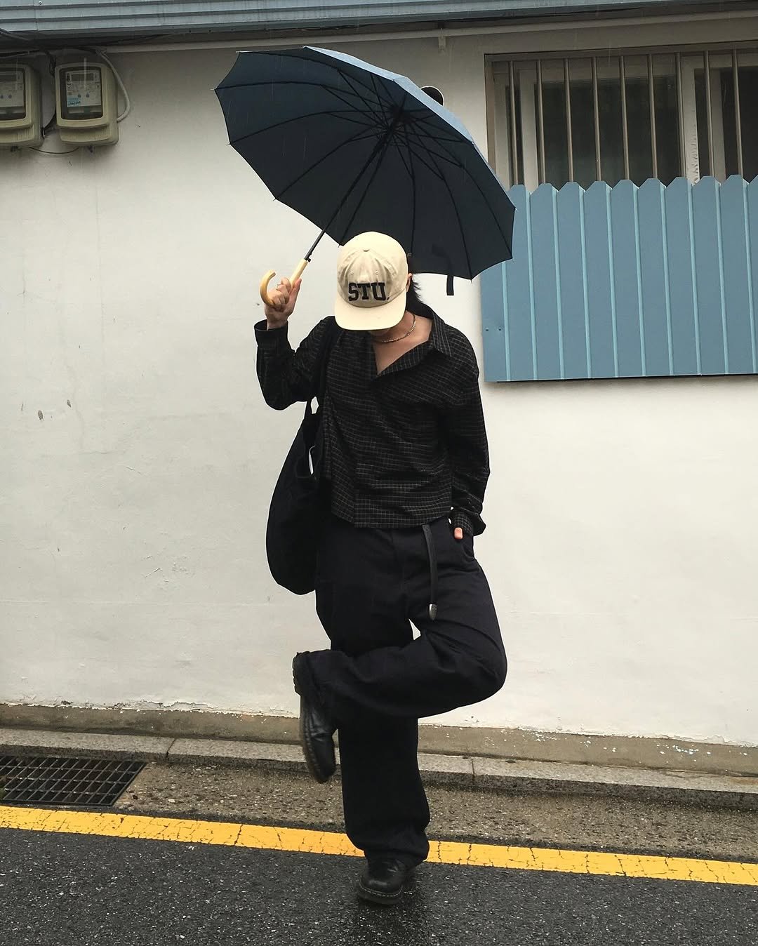 Photo shared by 민 서 on September 23, 2025 tagging @etce_official, @divein.kr, and @suade.design. May be an image of 1 person, duffle coat, umbrella, parasol, bowler hat, beret, street and text.