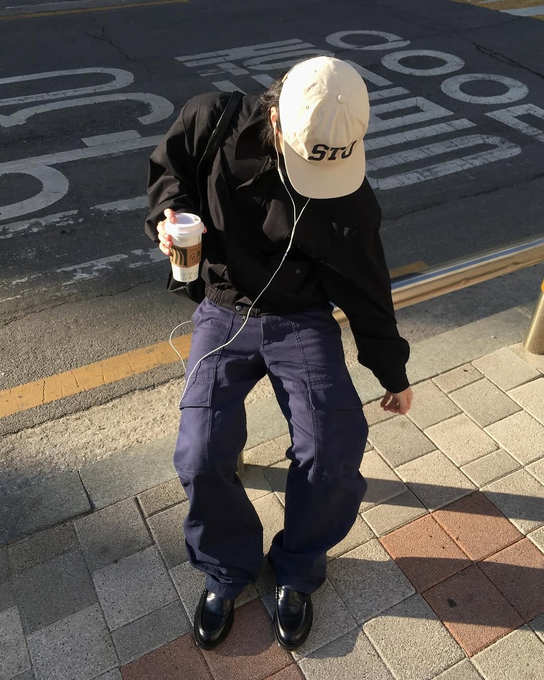 Photo shared by 민 서 on March 18, 2026 tagging @drmartenskr. May be an image of duffle coat, face mask, parka, sweatpants, street and text that says 'รณ'.