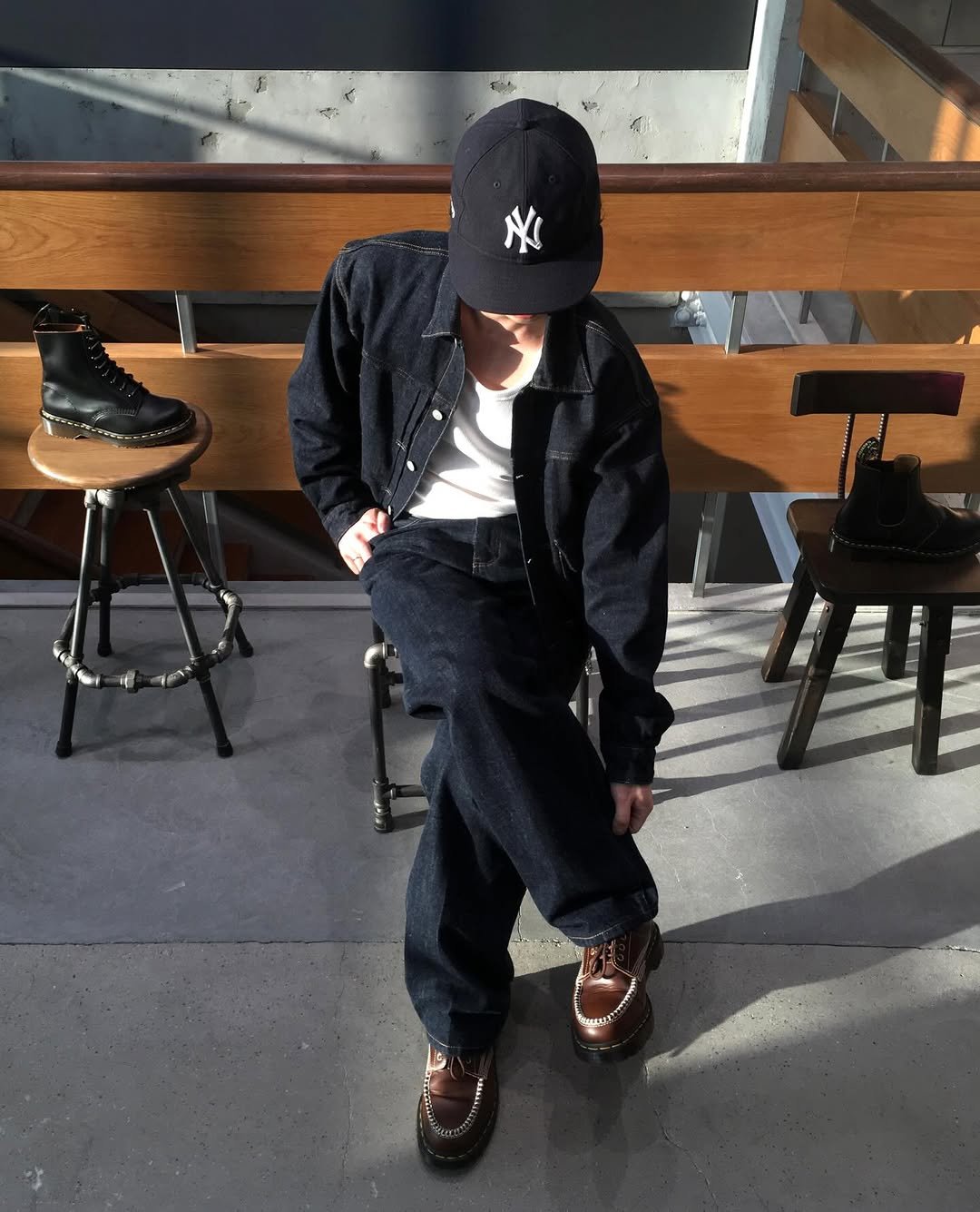 Photo shared by 민 서 on March 27, 2026 tagging @drmartenskr. May be an image of wingtip shoes, duffle coat, hat and text.